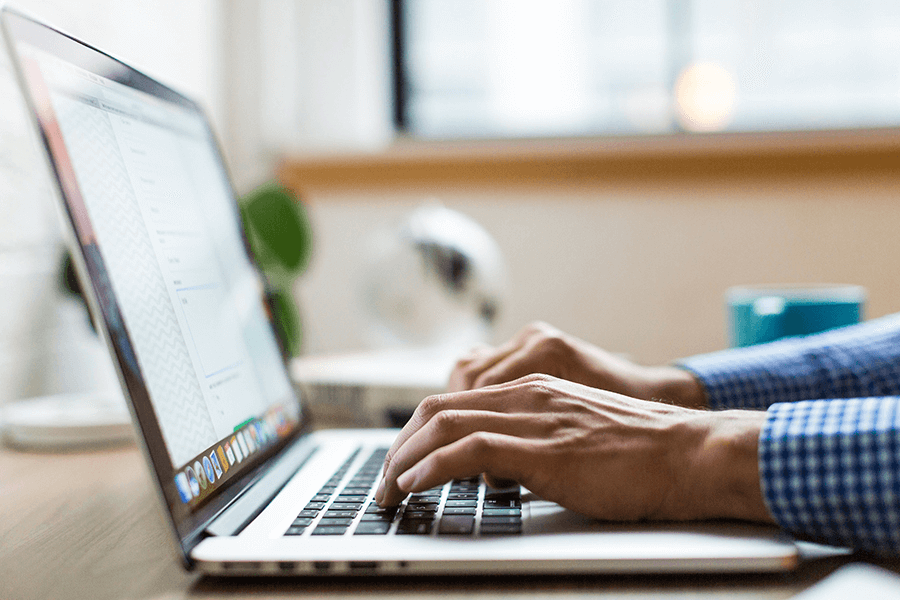 4 ways schools can drive edtech ROI hands on laptop keyboard featured